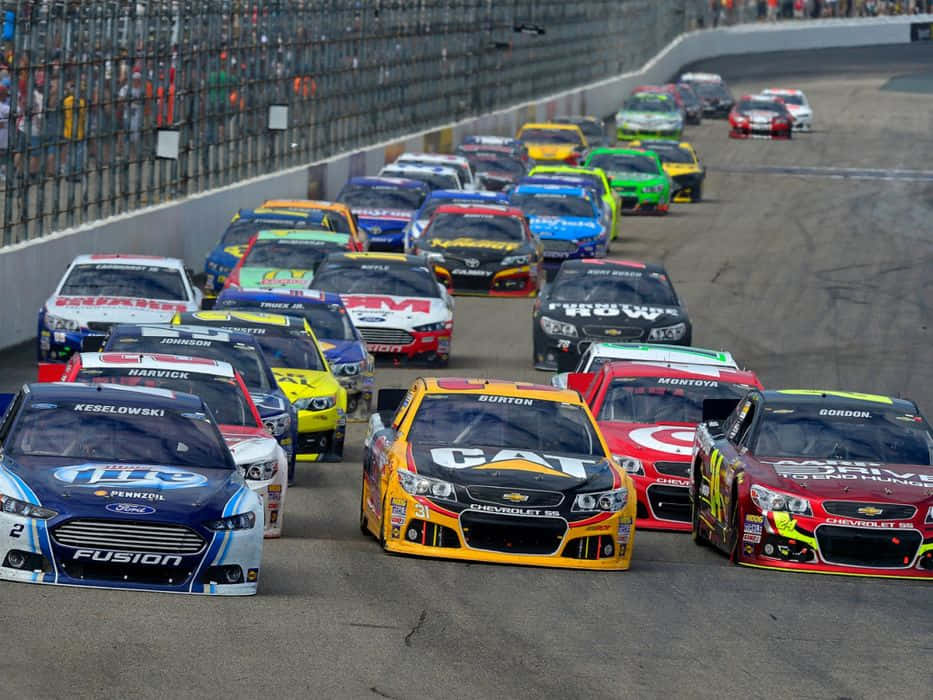 Nascar Cars Are Racing Down The Track