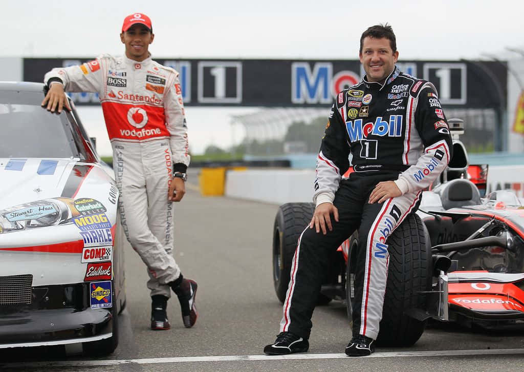 Two Nascar Drivers Pose Next To Their Cars