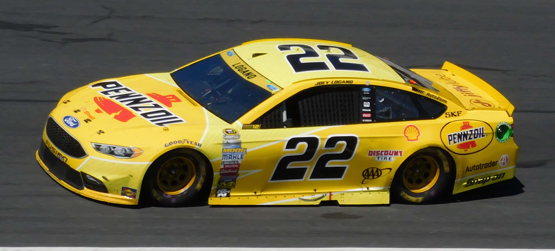 A Yellow Nascar Car With Number 22 On It