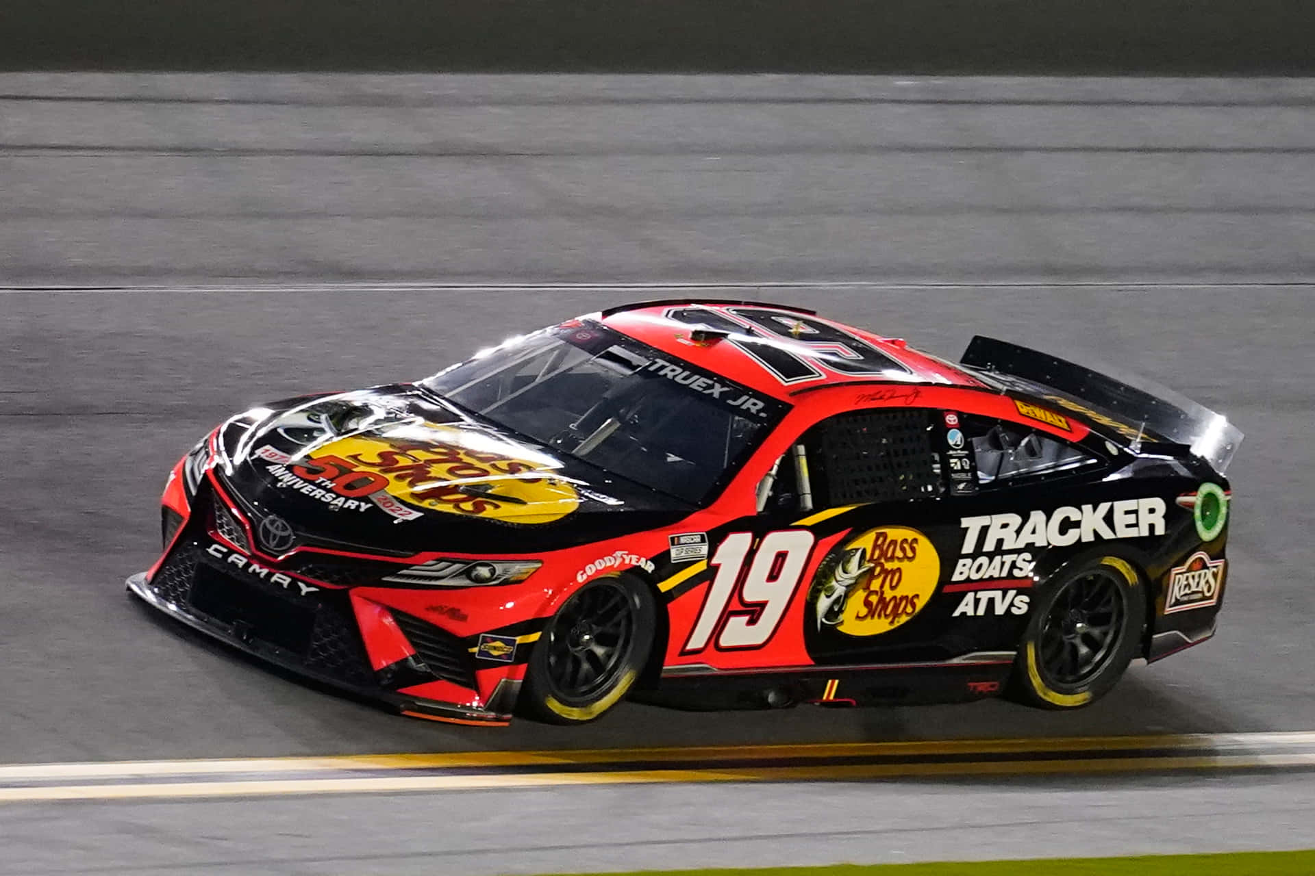 A Nascar Car Is Driving On A Track