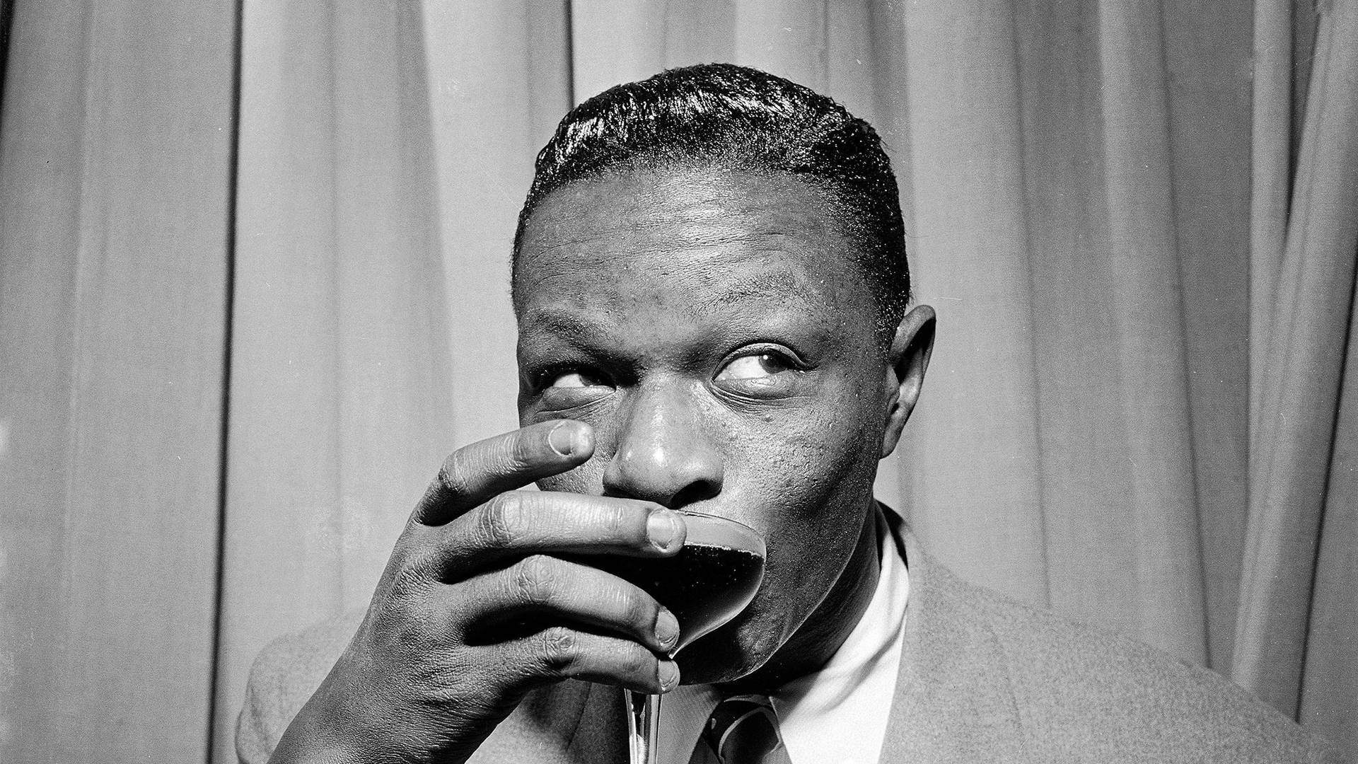 Nat King Cole Sipping A Drink Wallpaper