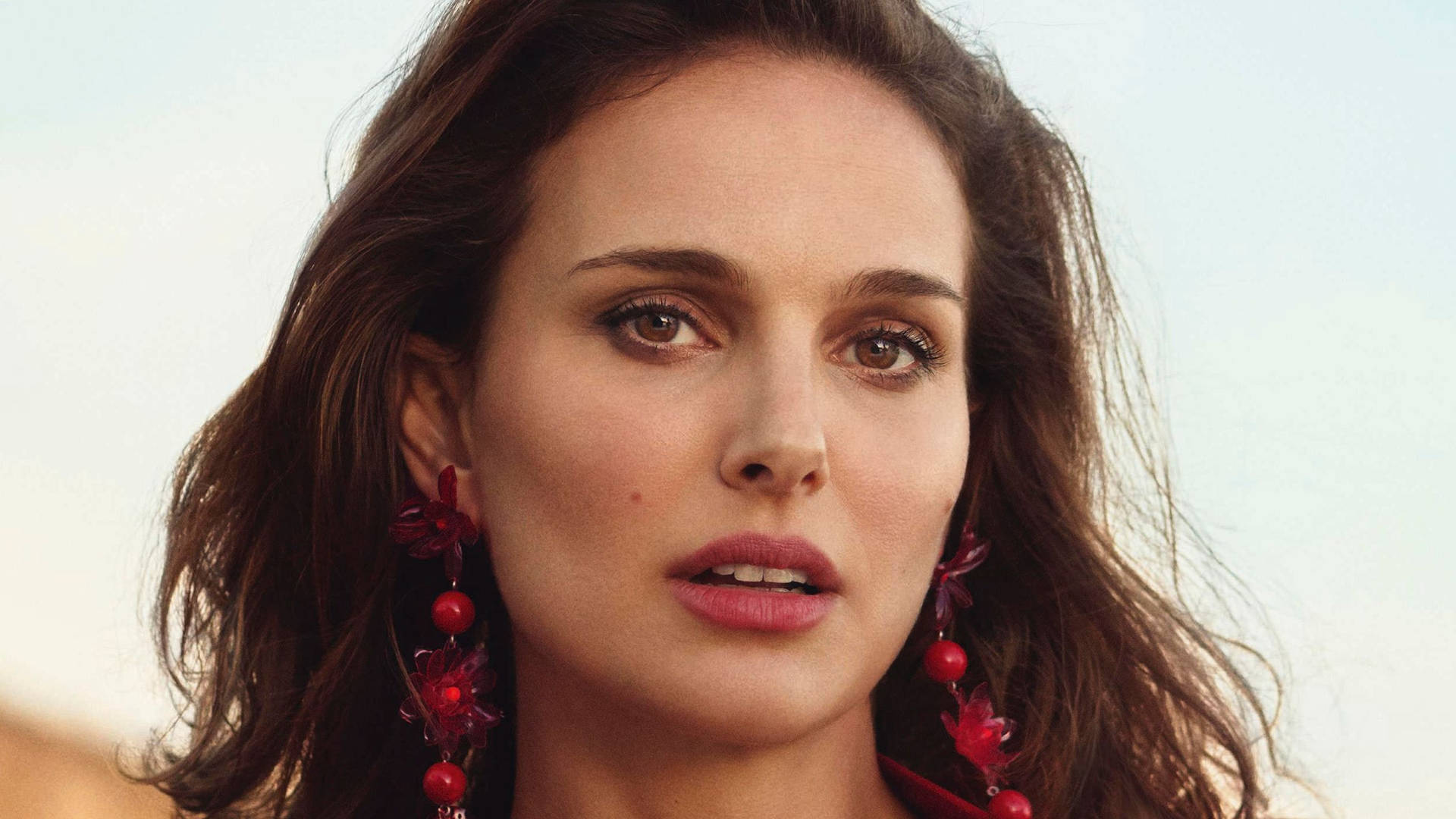 Natalie Portman Exemplifying Elegance with Red Earrings Wallpaper