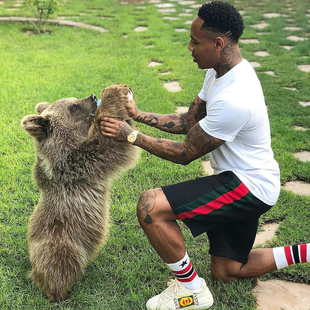 Nathaniel Clyne Playing With Bear Wallpaper