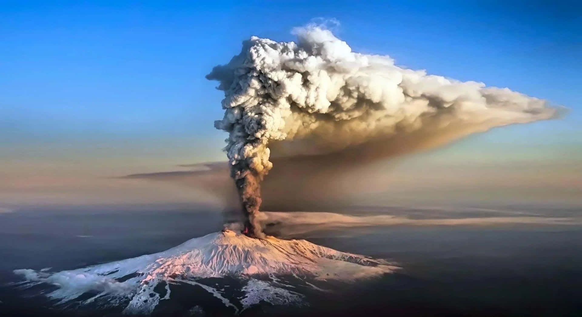 A Volcano Is Spewing Smoke From The Top Of It