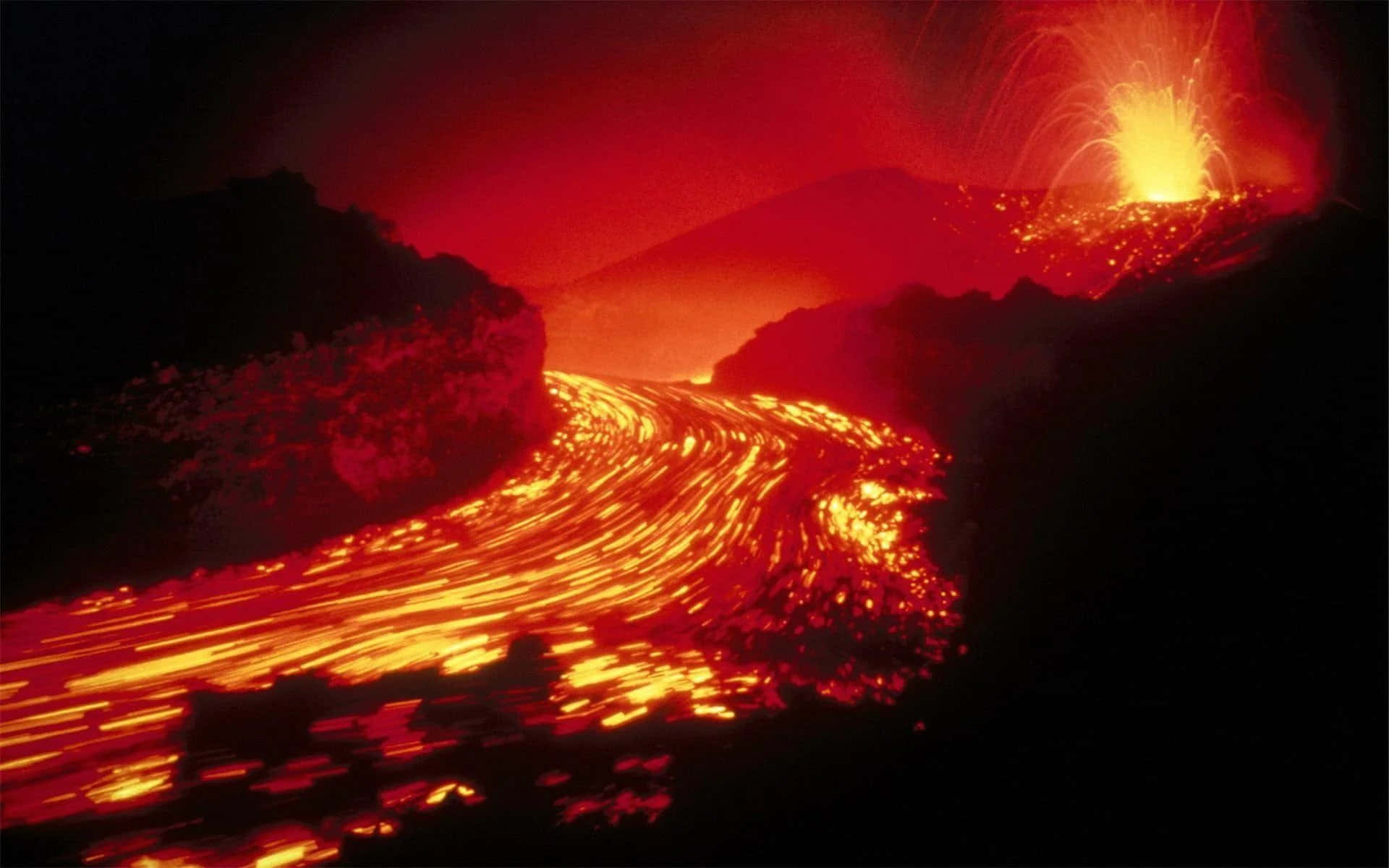 A Volcano With Lava Flowing Out Of It