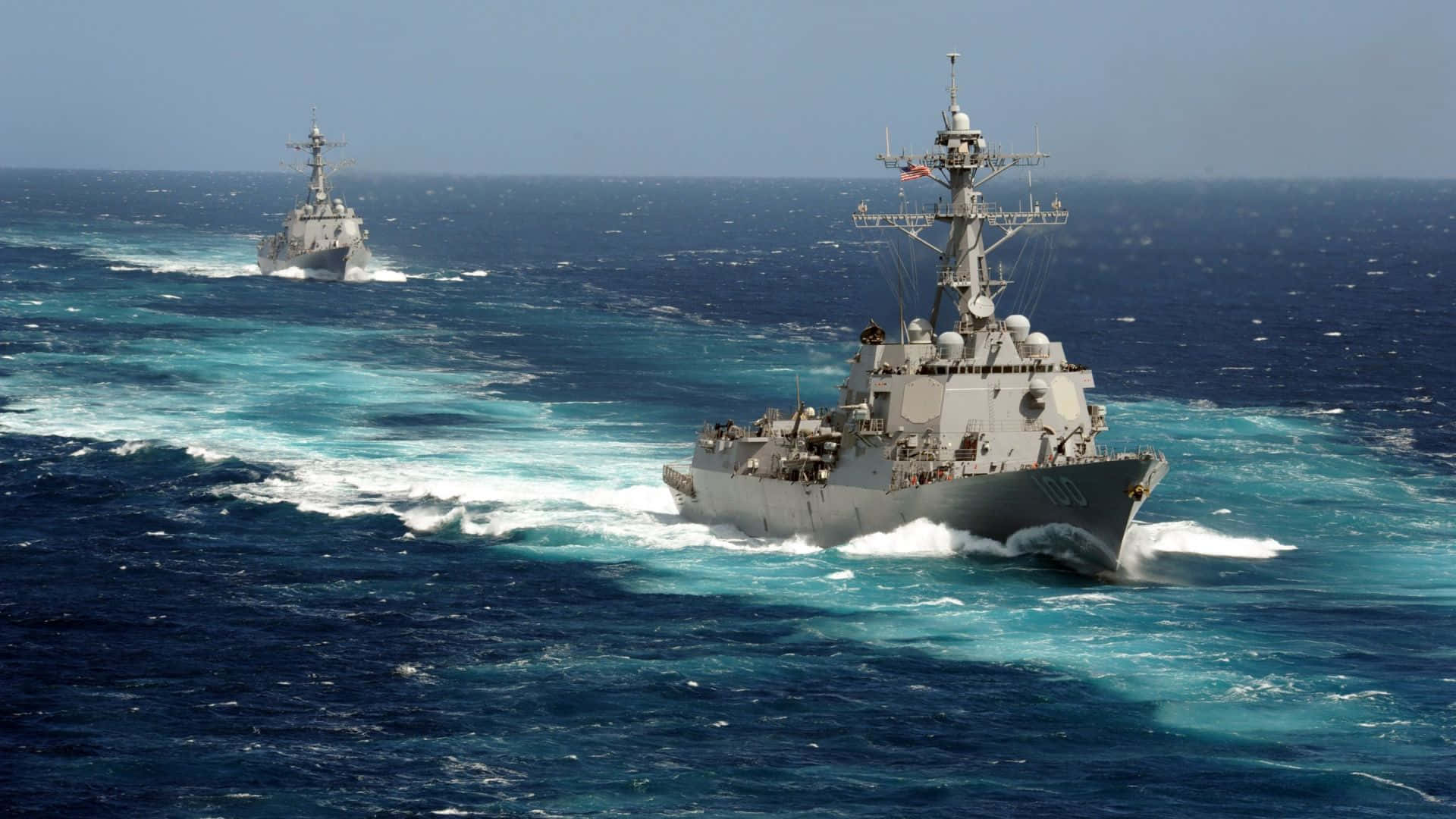 Two Navy Ships Sailing In The Ocean