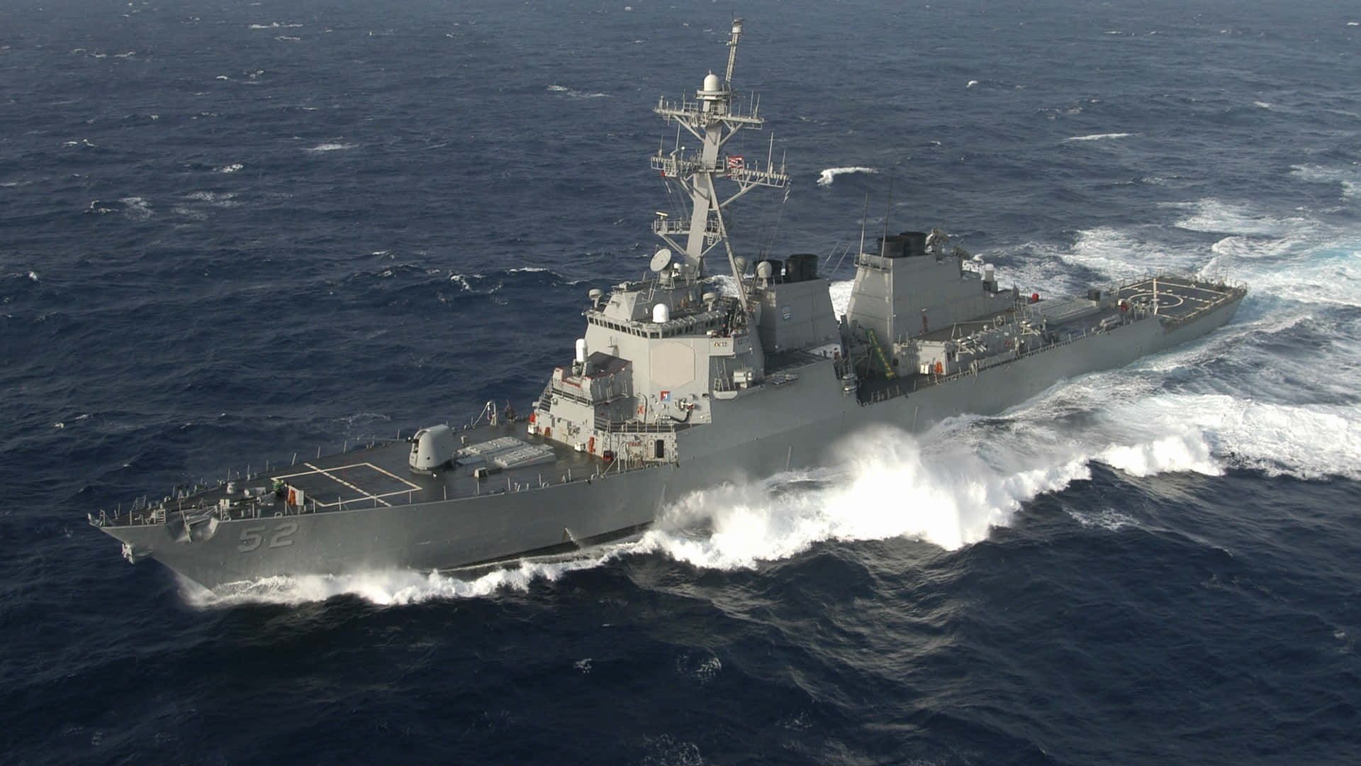 A Navy Ship Is Traveling In The Ocean