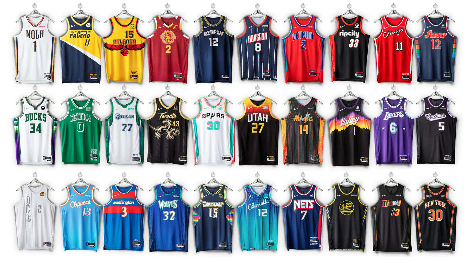 a collection of basketball jerseys hanging on a wall Wallpaper