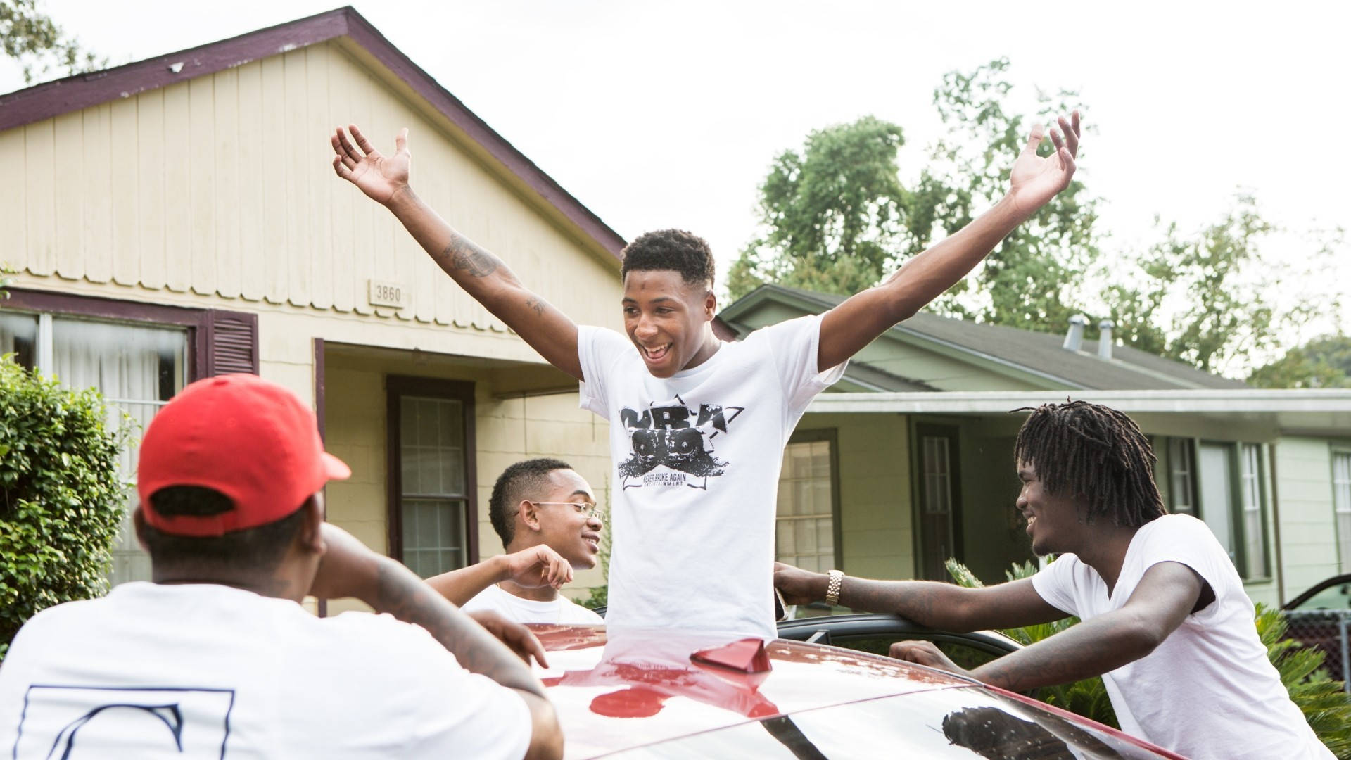 NBA Youngboy enjoying time with friends Wallpaper