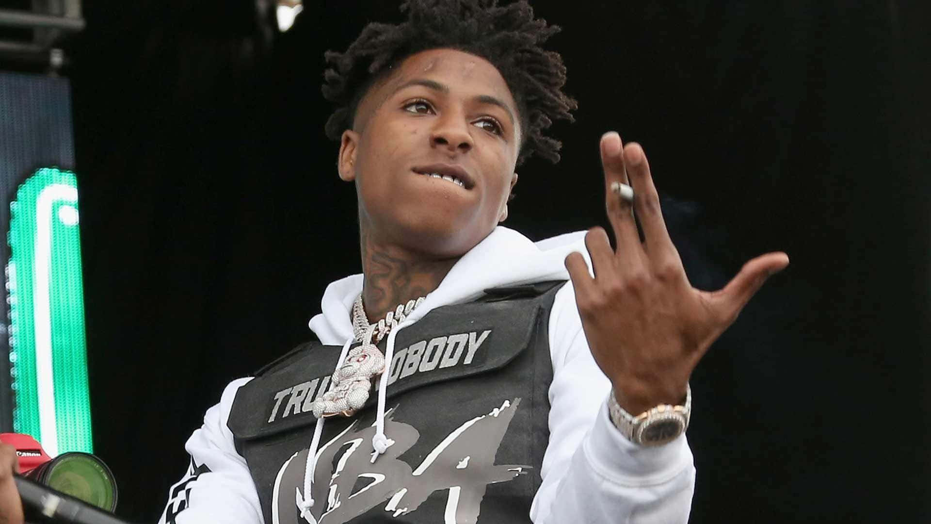 Nba Youngboy showing off his luxurious jewelry look.