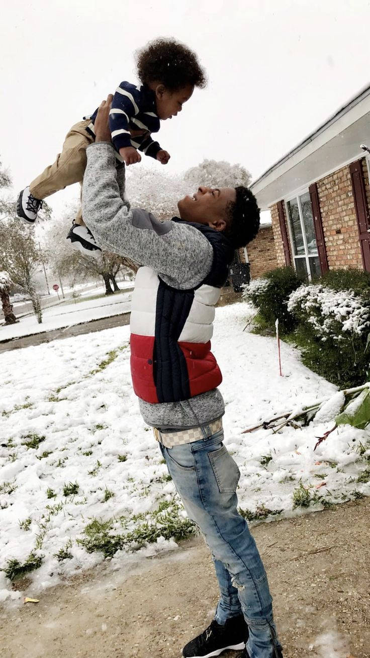 Nba Youngboy With Kid In Winter Background