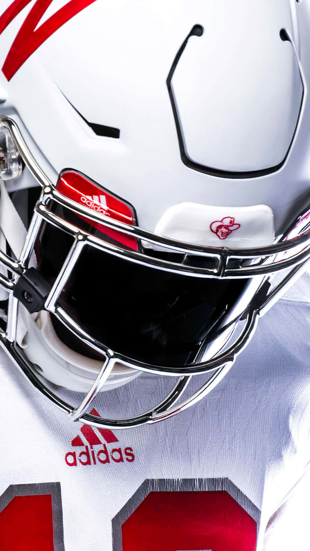 A White Football Helmet With Red Stripes Wallpaper