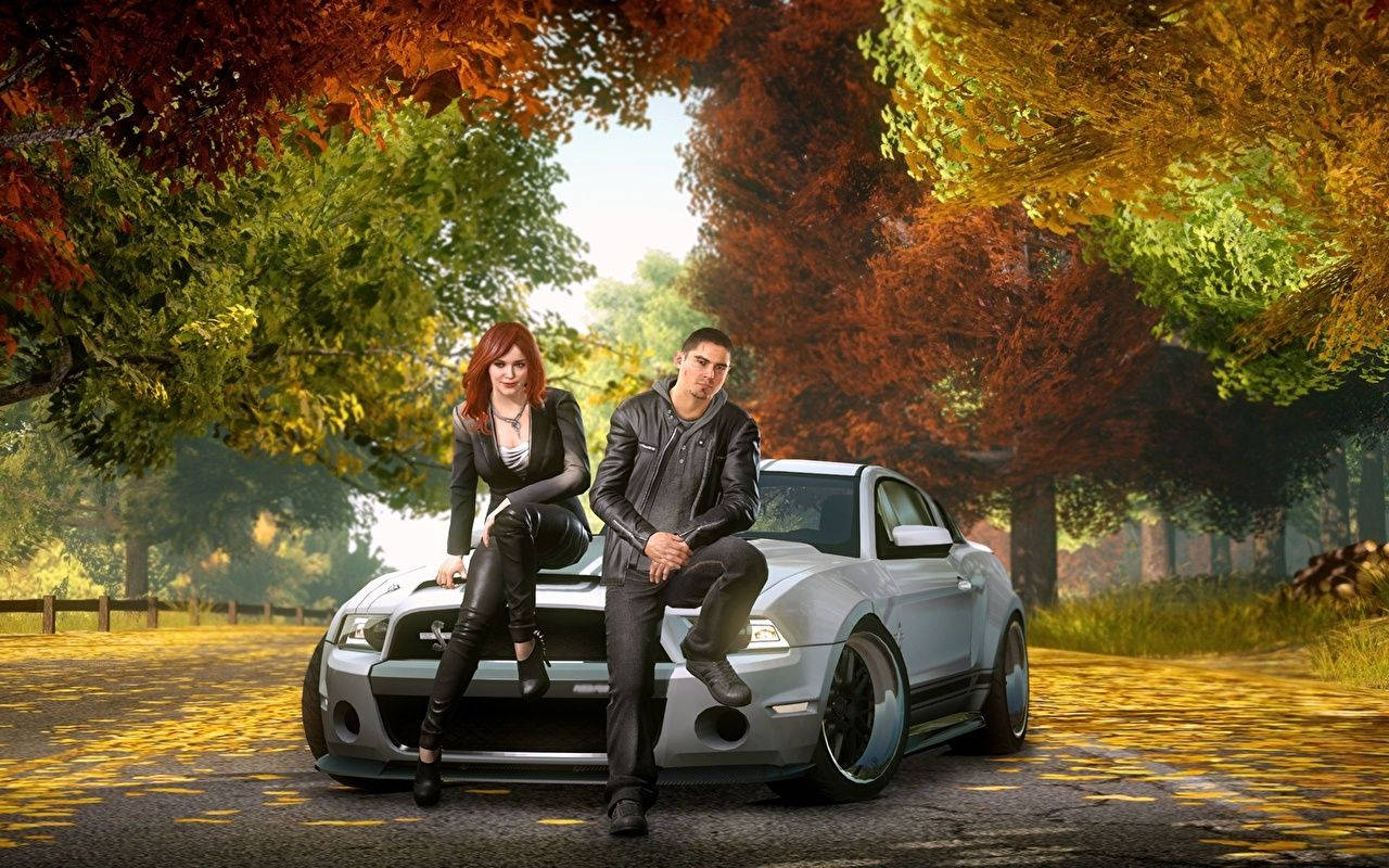 En mand og kvinde sidder på en bil i efteråret. Wallpaper