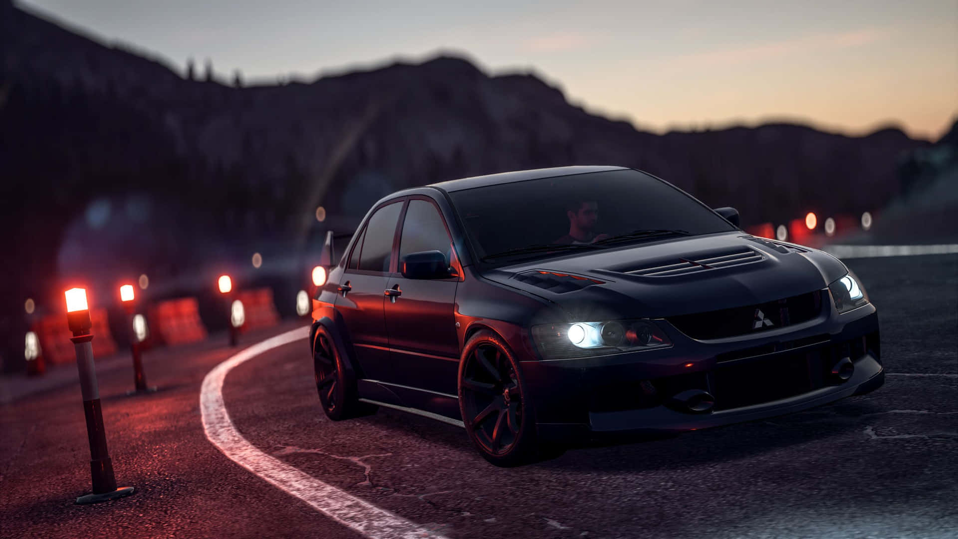 A Black Car Driving Down A Road At Night