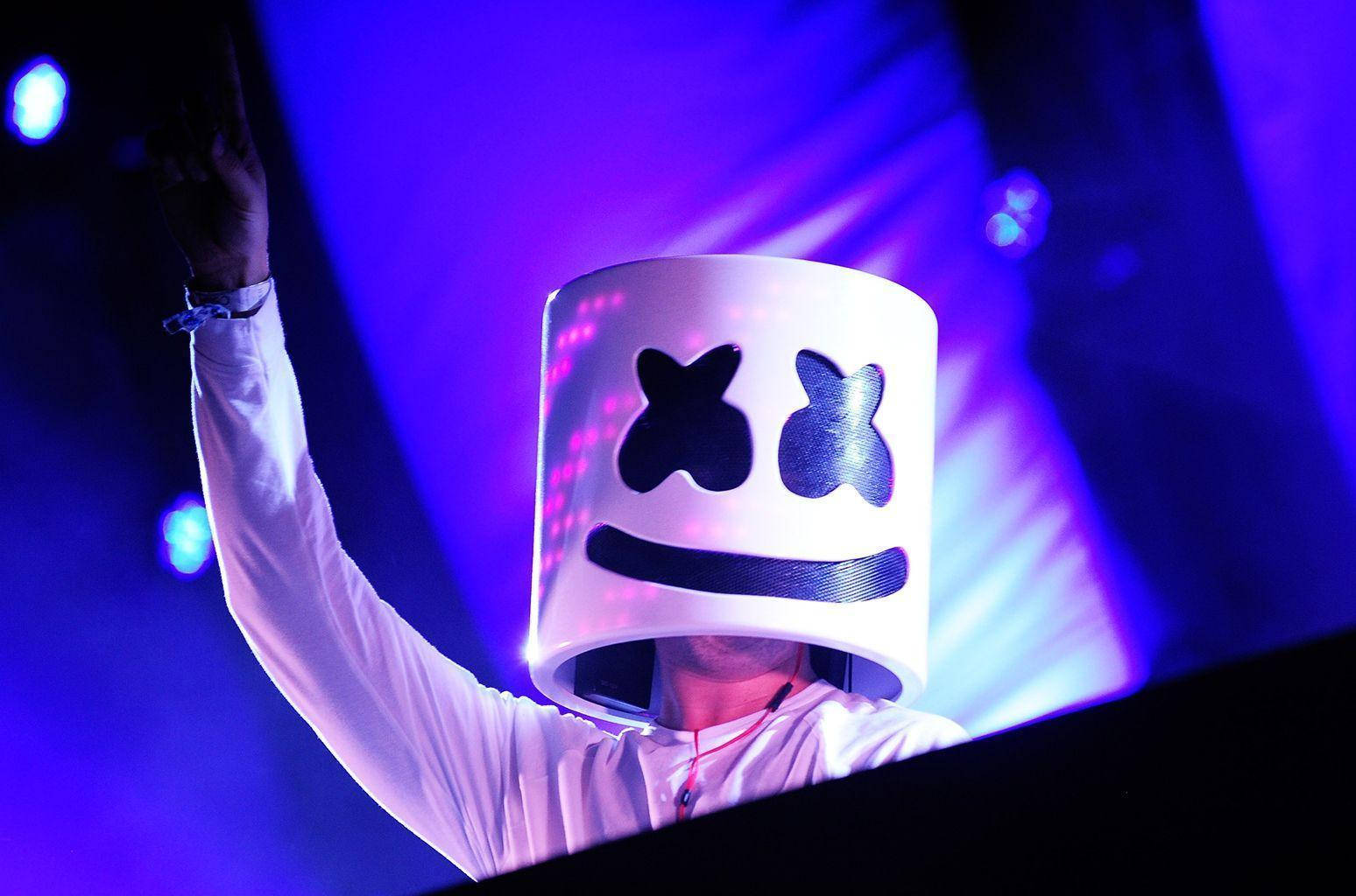 Marshmello performing on a neon-lit blue stage Wallpaper