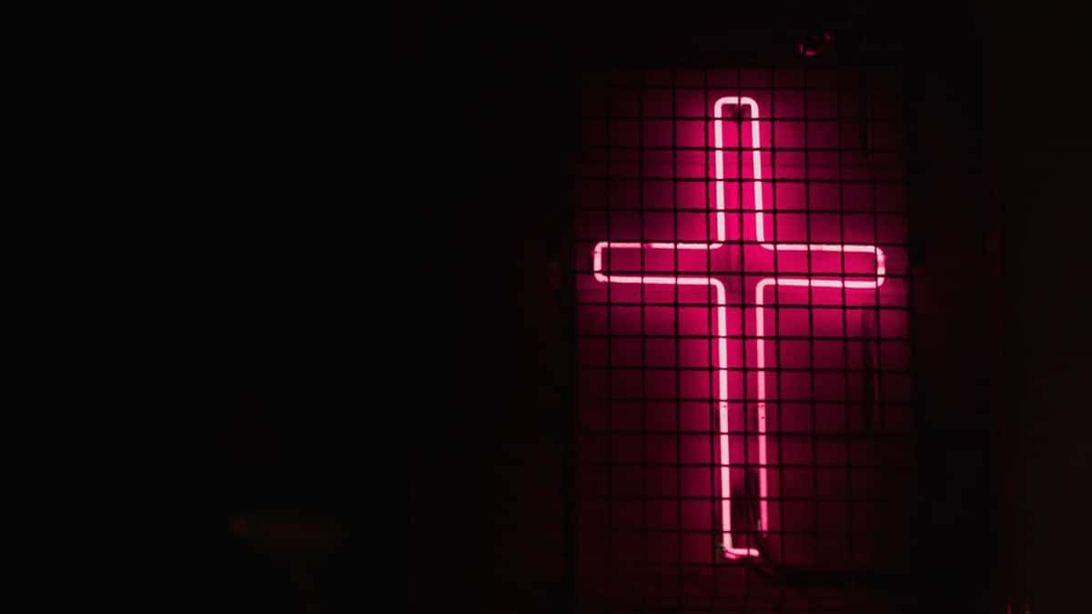 A Neon Cross Creates a Mystical Scene of Faith Wallpaper
