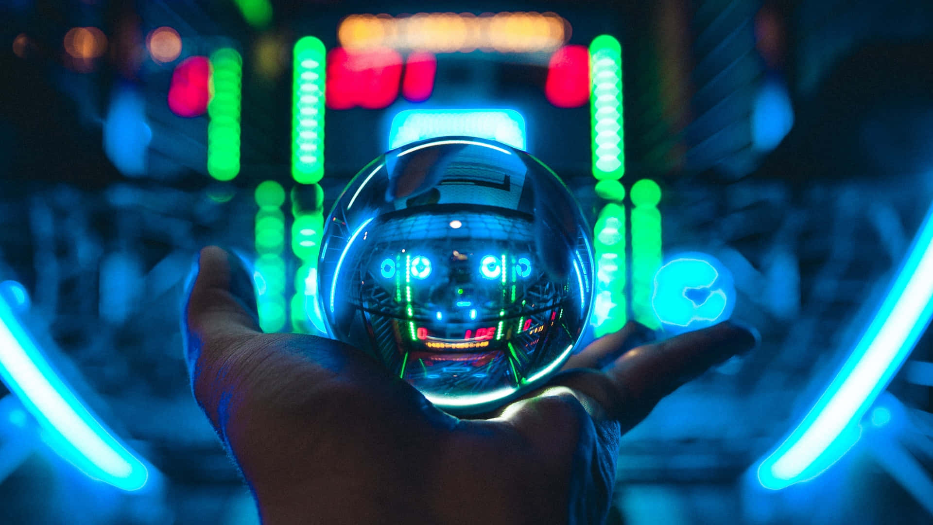 A Hand Holding A Glowing Ball In Front Of Neon Lights Wallpaper
