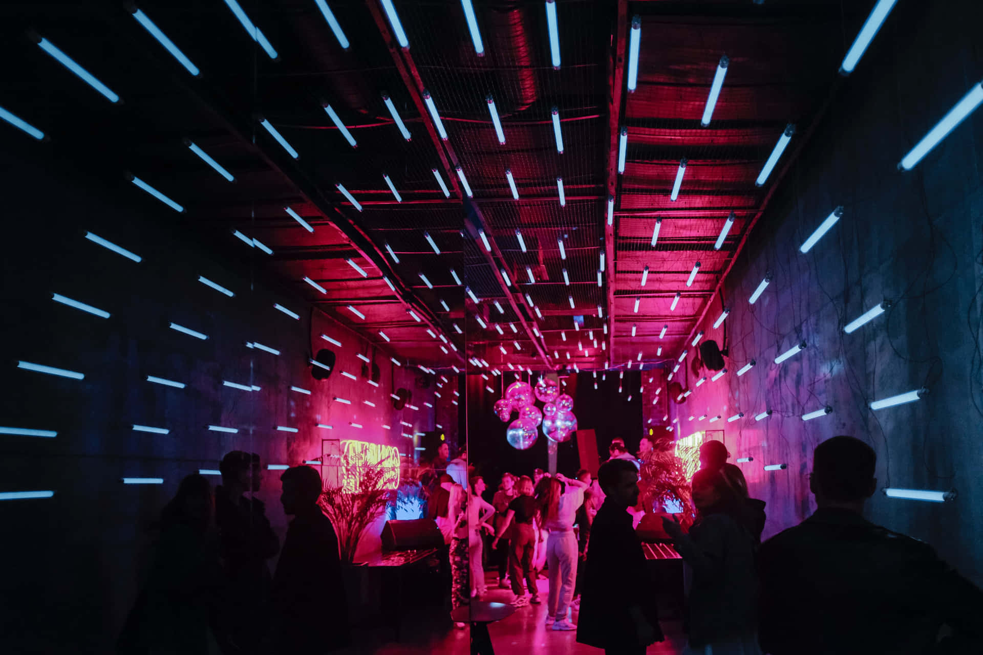 Neon Lit Dance Club Scene Wallpaper