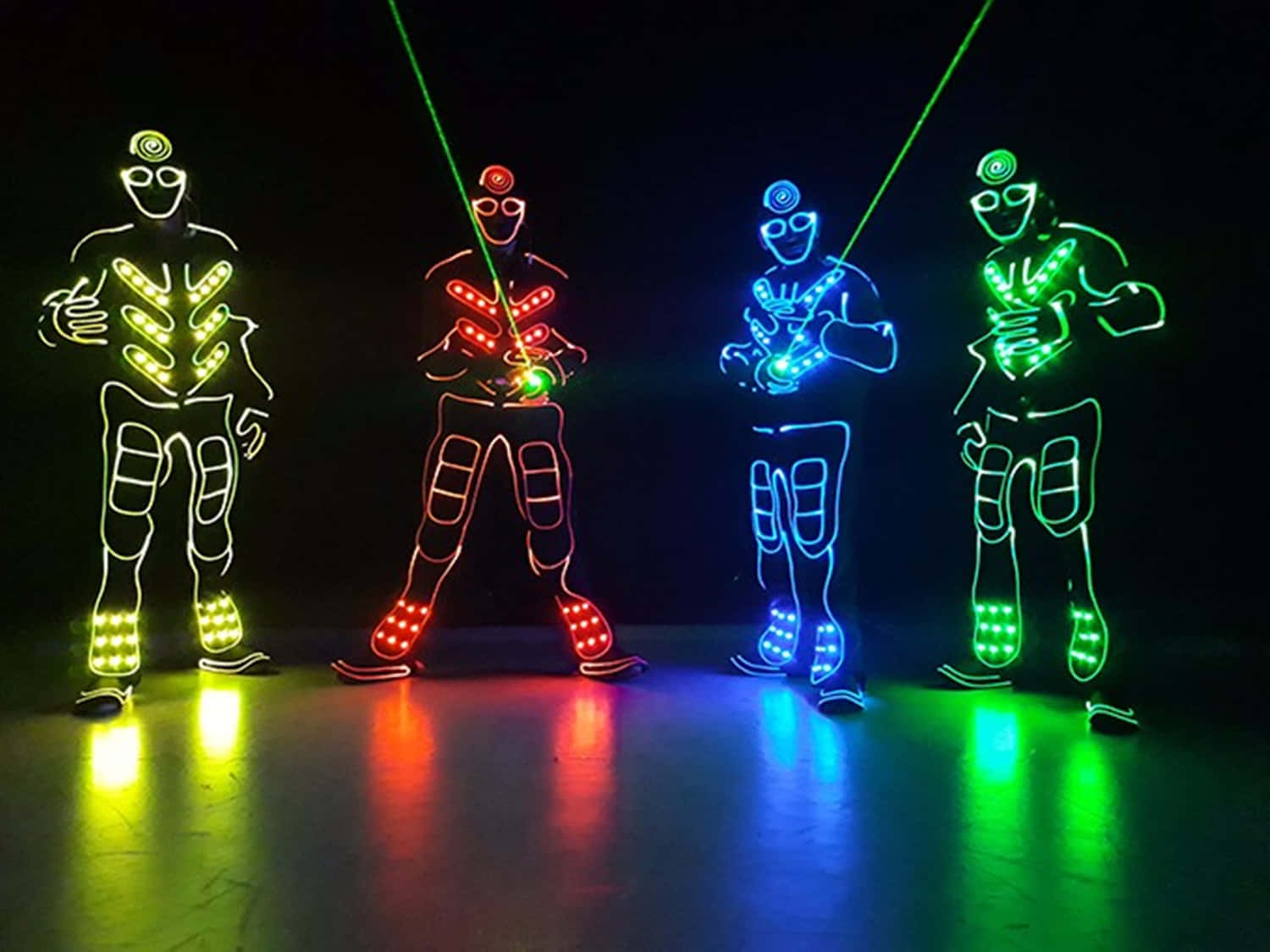 Neon Lit Dancers In Dark Room Wallpaper