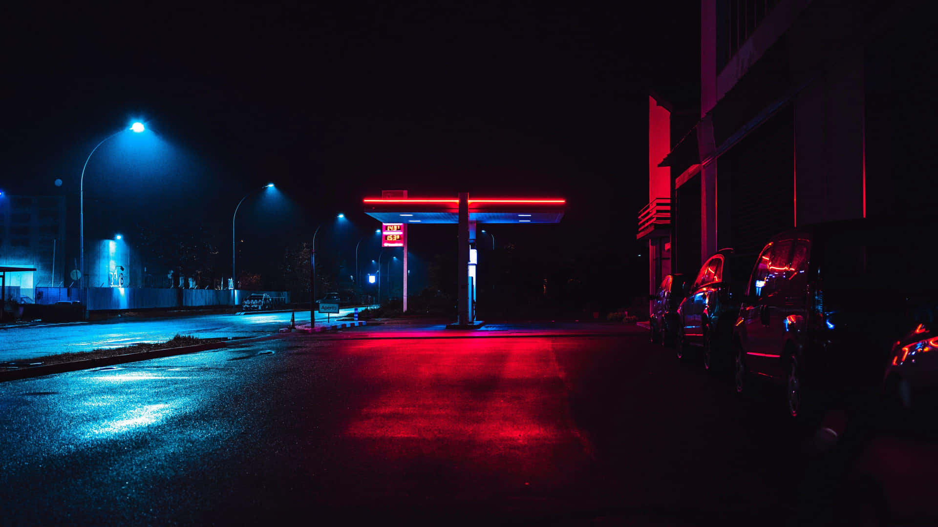 Neon Lit Gas Stationat Night Wallpaper