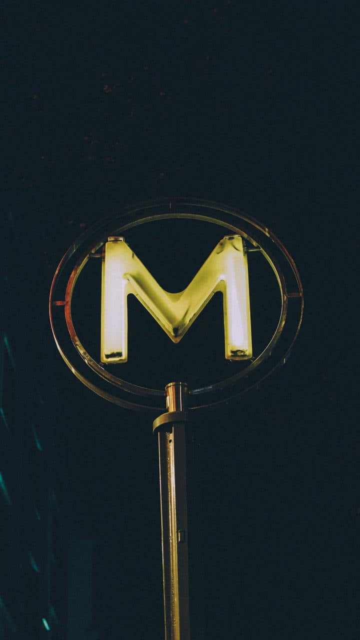 Neon Lit M Letter Sign Wallpaper