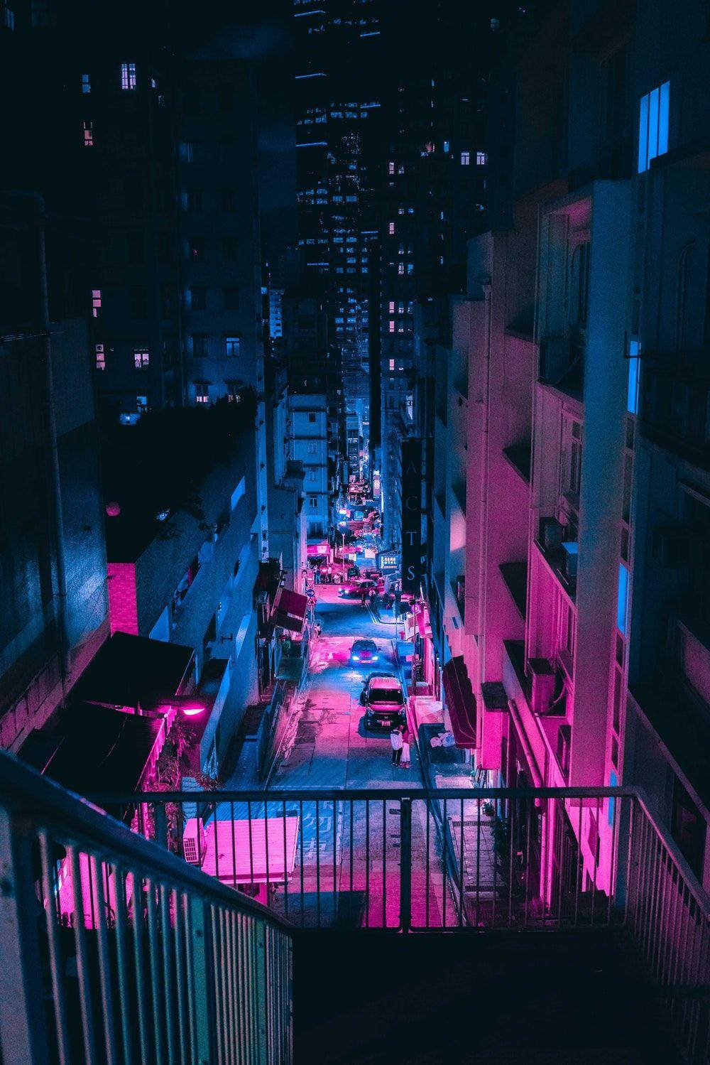 Vistasulla Città Rosa Neon E Blu Dal Balcone Sfondo