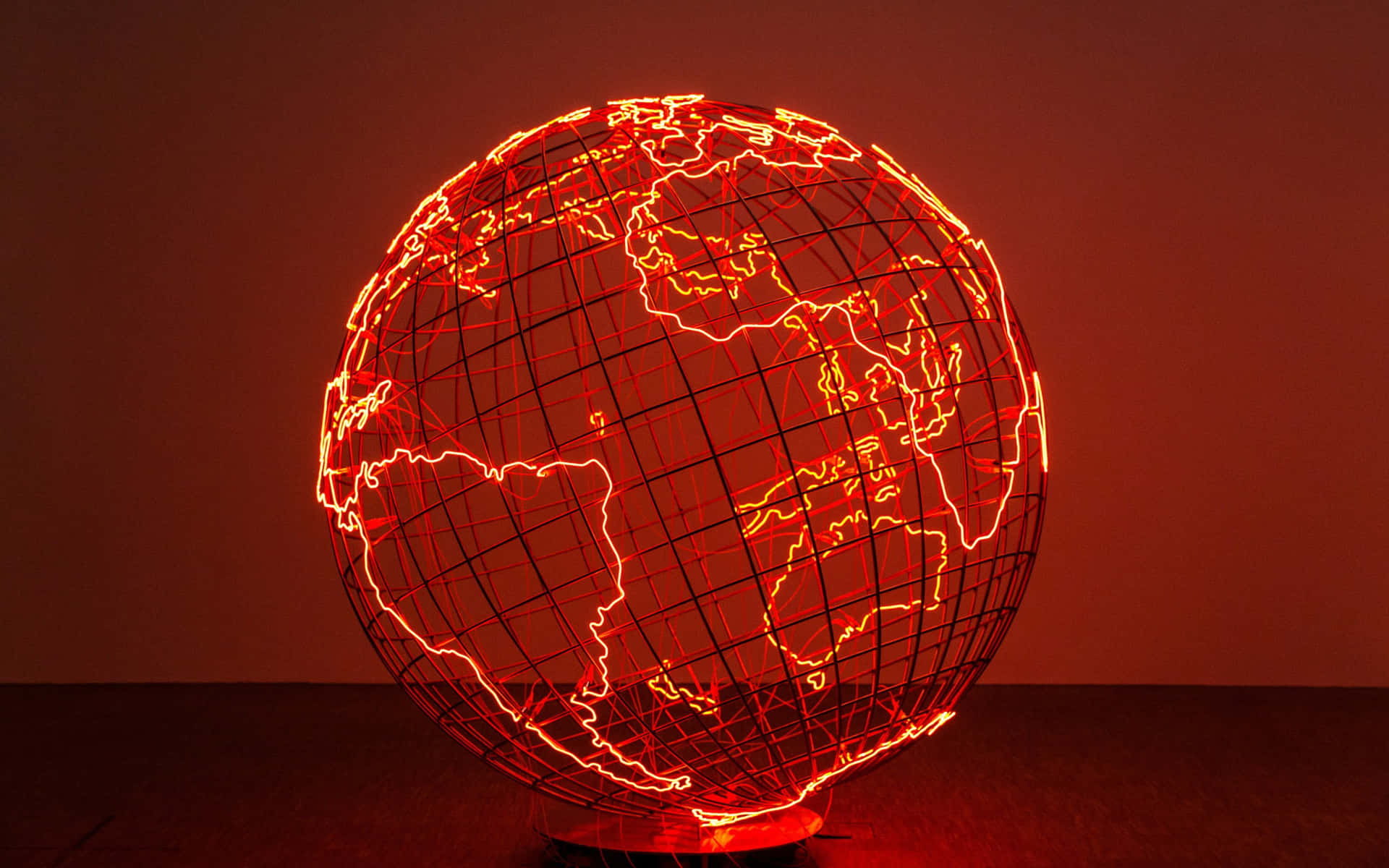 Neon Red Sculpture Of Globe Map Wallpaper