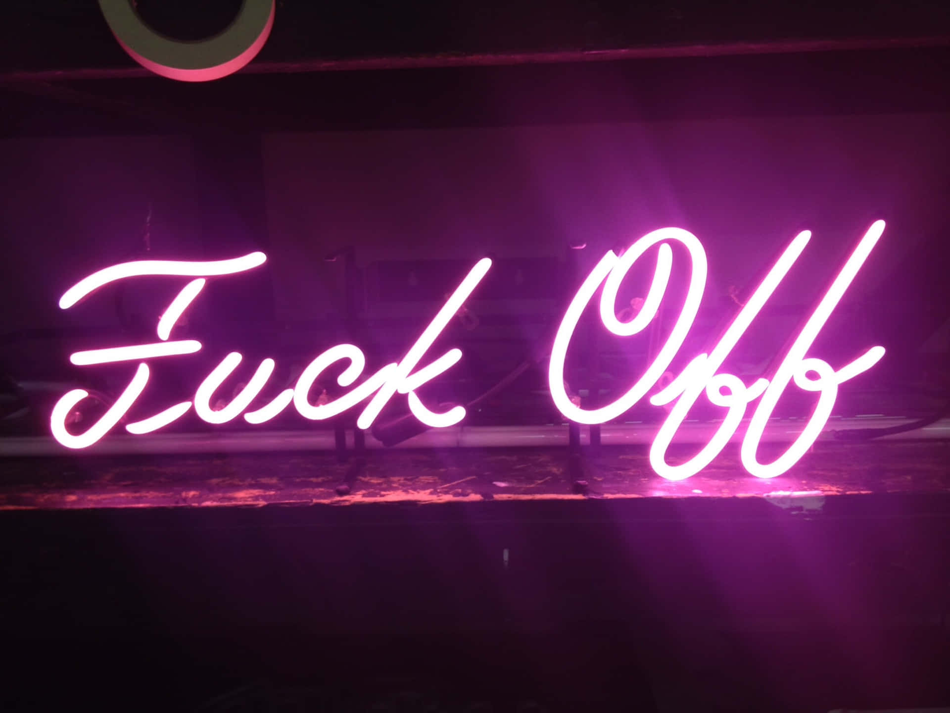 Illuminated Neon Sign in a Dark Environment