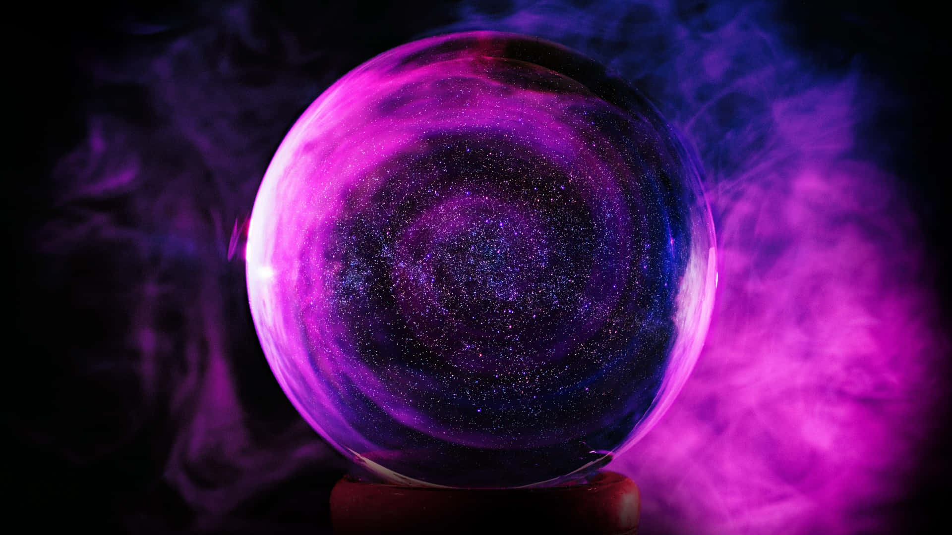 A Purple And Pink Crystal Ball With Smoke Coming Out Of It Wallpaper