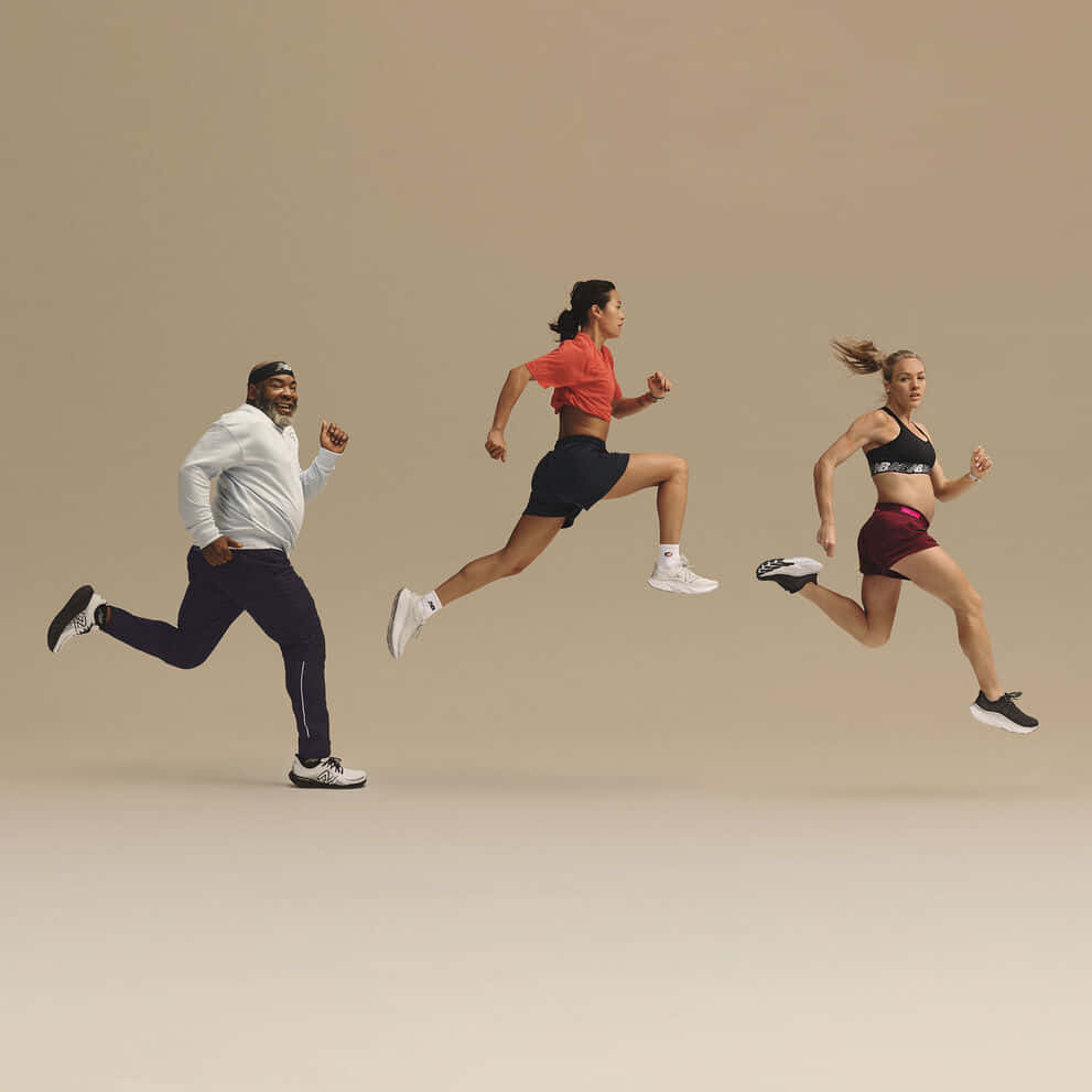 A Group Of People Running In A Group