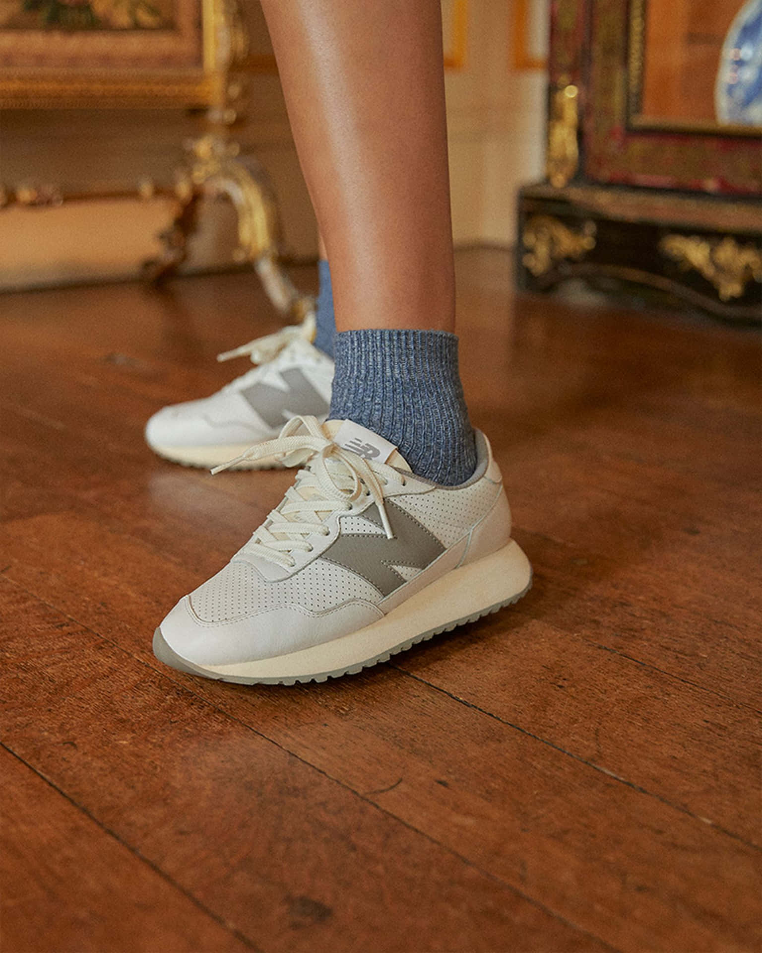A Woman Wearing A White And Grey Sneaker