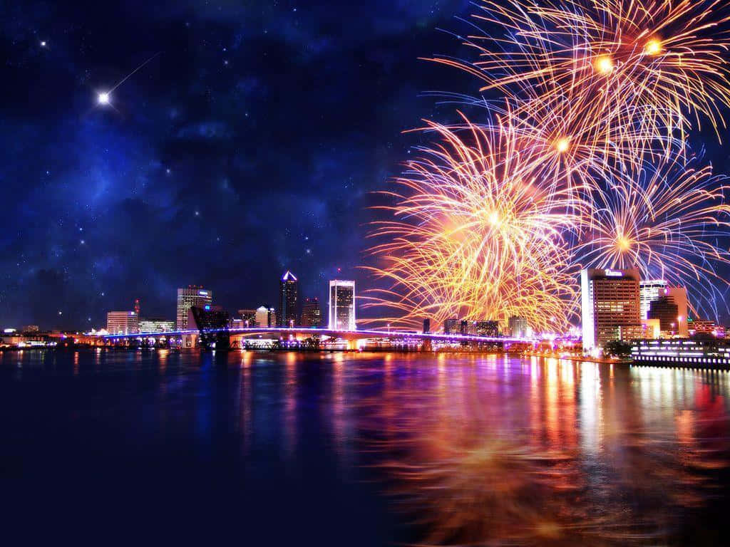 A City With Fireworks Over The Water Wallpaper