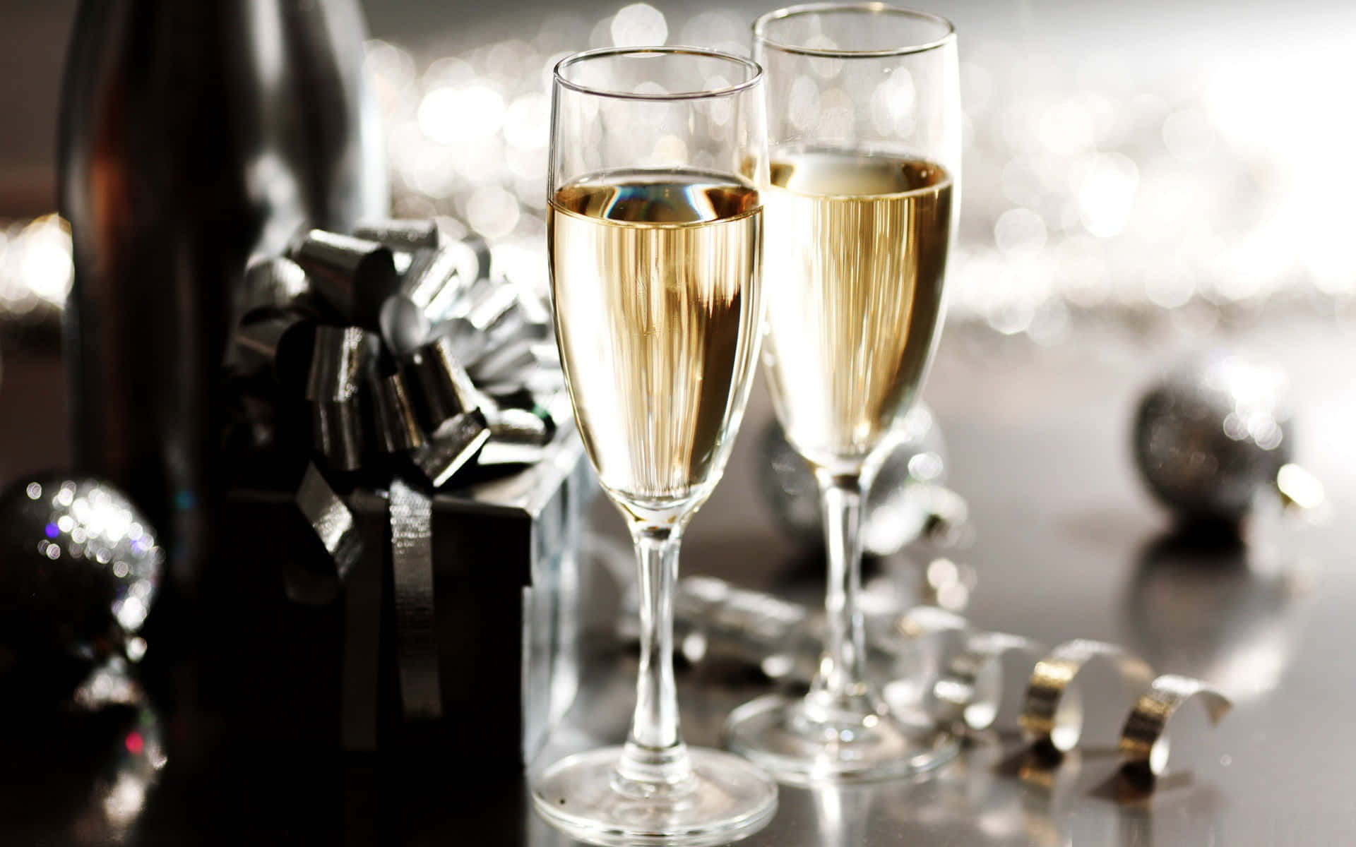two glasses of champagne on a table with decorations