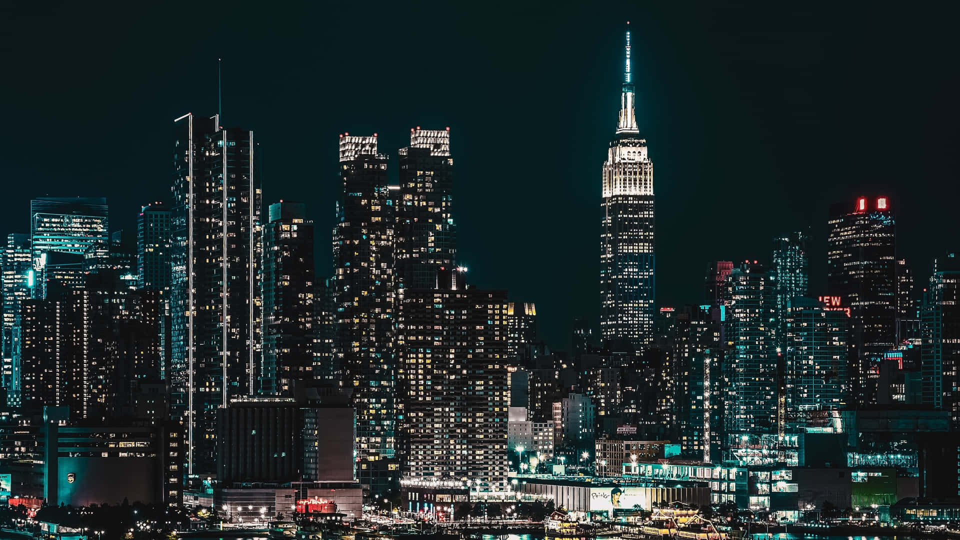 Bright lights of New York City shine against the night sky