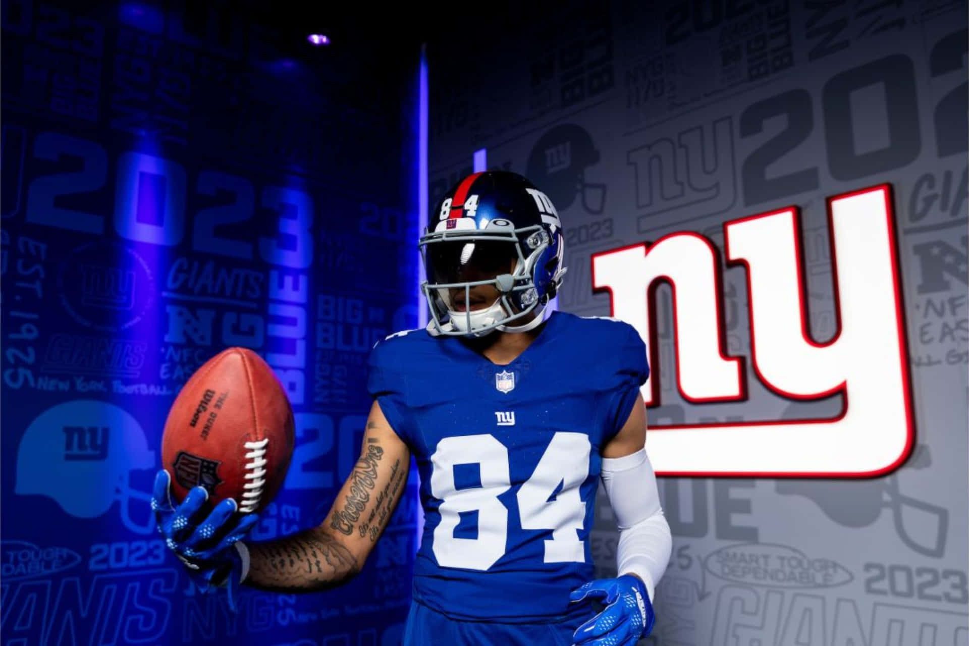 New York Giants Player Holding Football Wallpaper