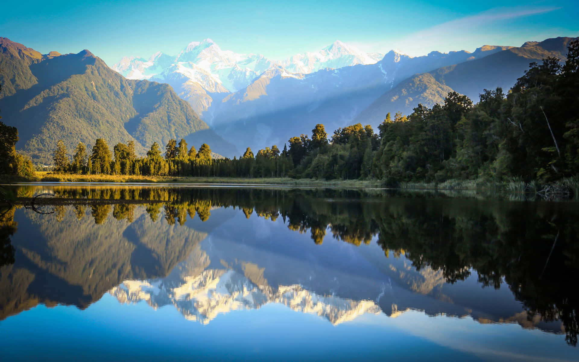 Download A Lake With Mountains Reflected In It | Wallpapers.com