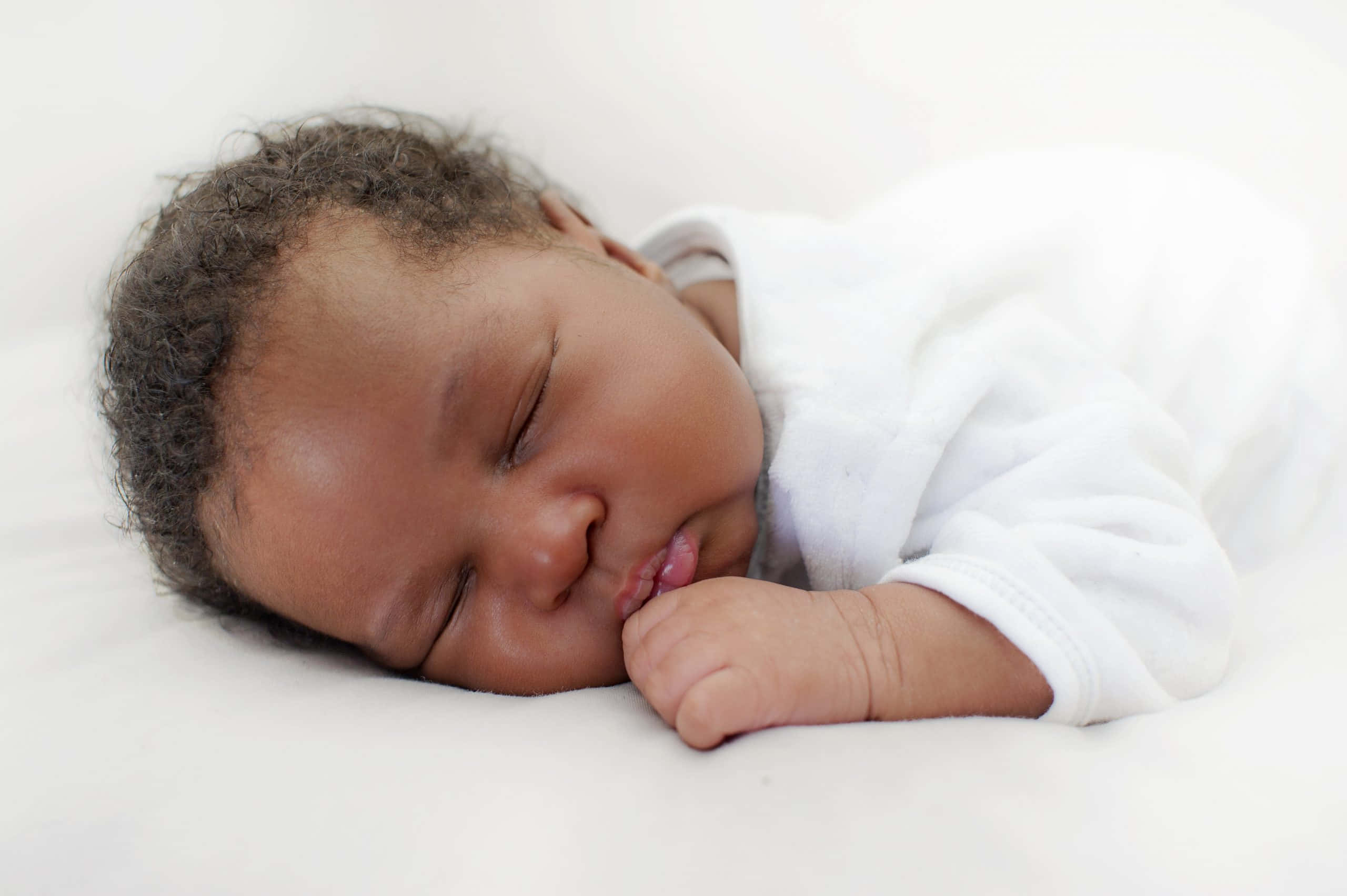 Adorable Newborn Baby Sleeping Peacefully on a Soft Blanket