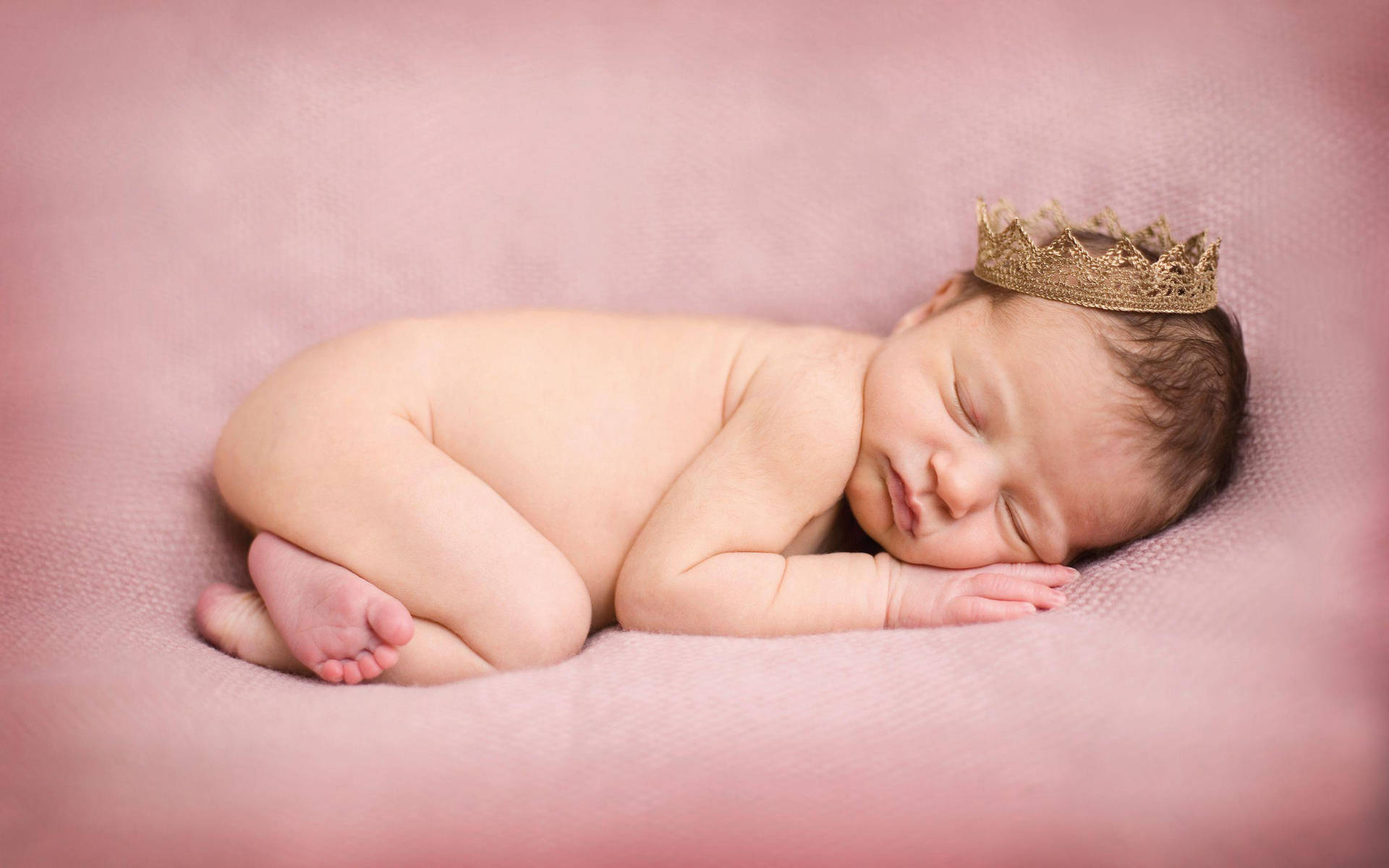 Newborn Baby Sleeping Serenely Wrapped In A Soft Blanket Wallpaper