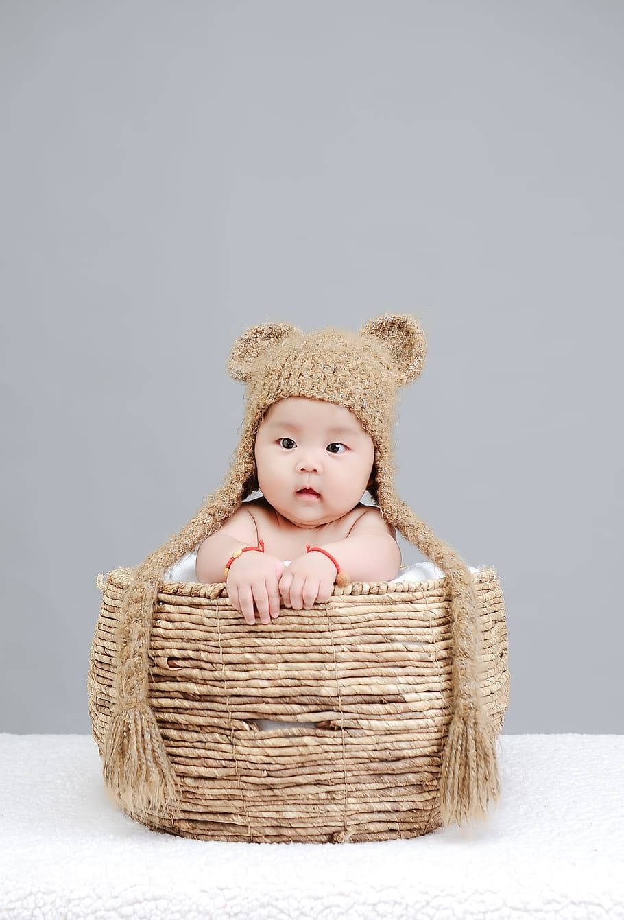 Newborn Child In A Knitted Basket Wallpaper