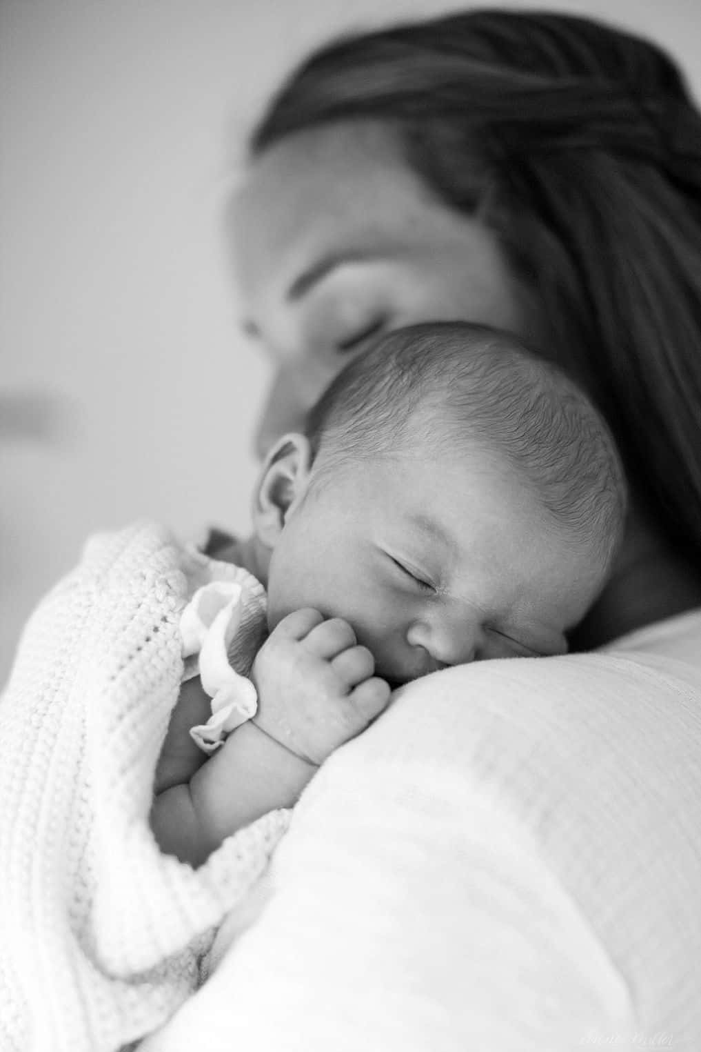 Newborn Black And White Sleeping On Mother's Shoulder Pictures