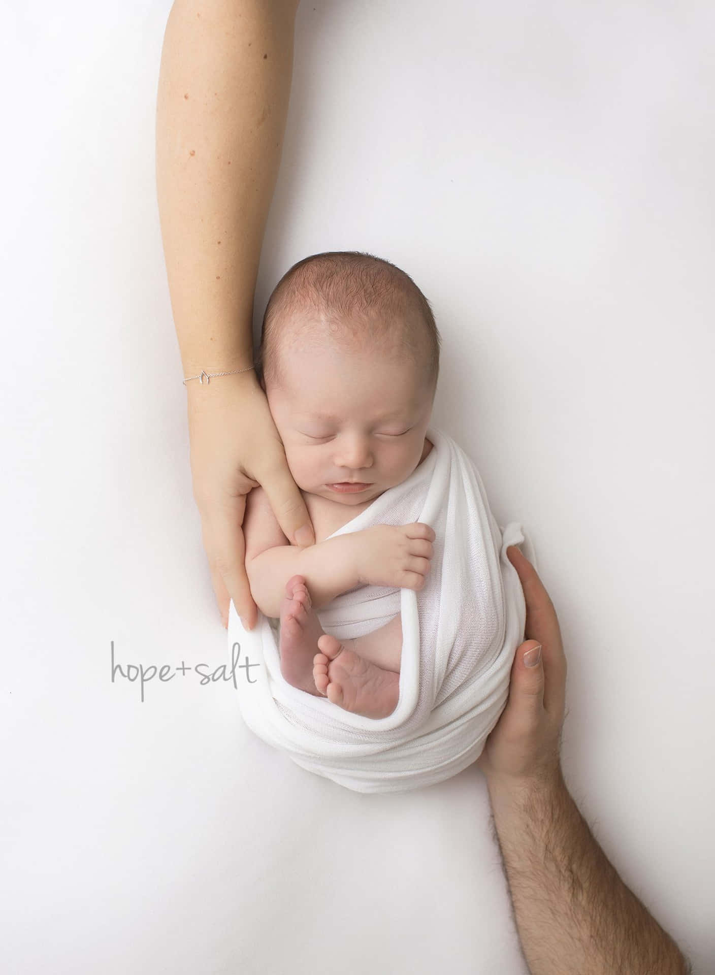 Newborn In Blanket Held By Two Hands Pictures