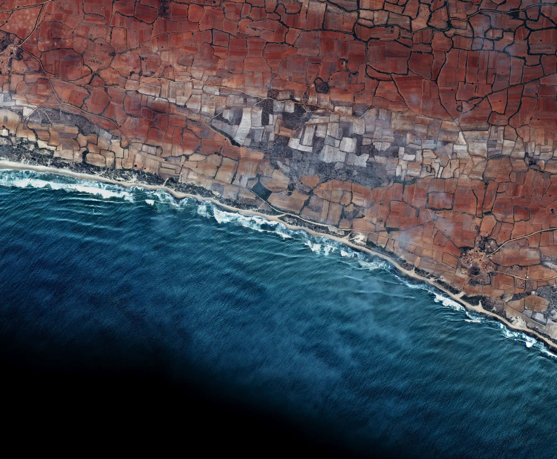 A Satellite Image Of The Ocean And Land Wallpaper