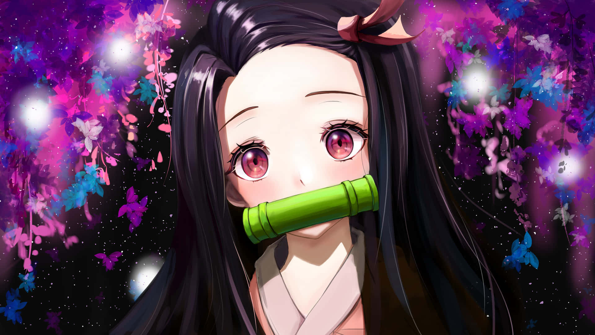 En pige med langt hår og grønne øjne holder en bambustav.
