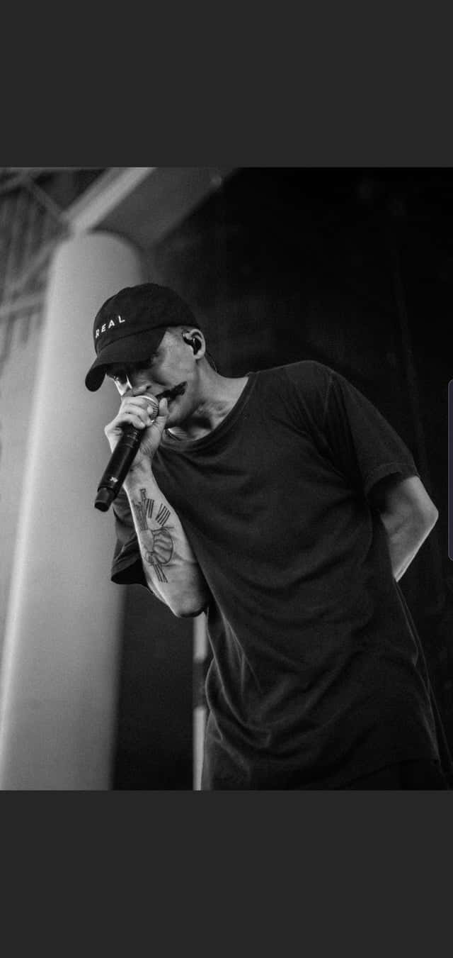 Rapper Nf Stands In A Valley Of Success Wallpaper