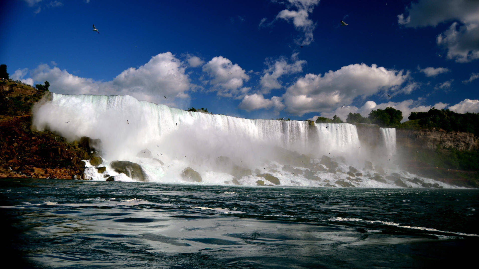 Caption: Breathtaking view of the vibrant Niagara Falls Wallpaper