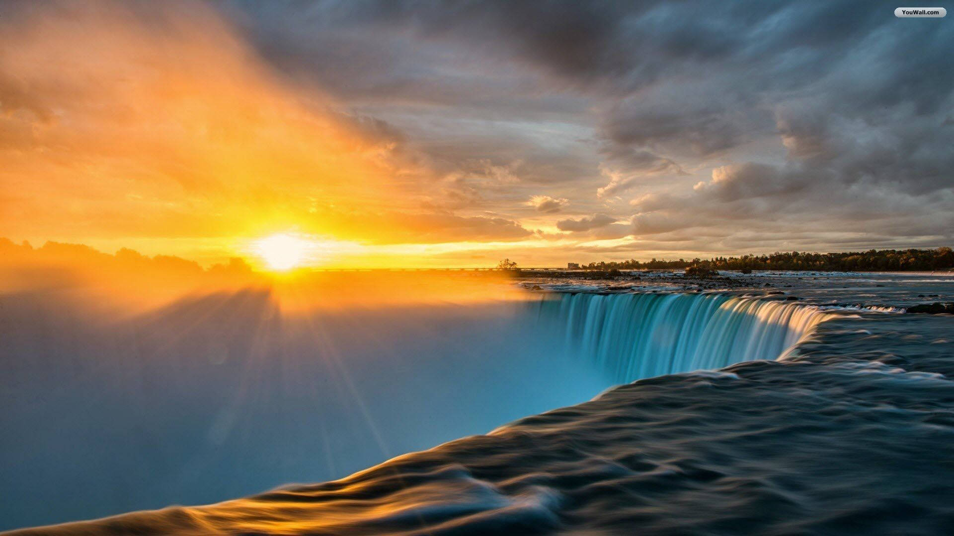 A glorious sunrise over the majestic Niagara Falls Wallpaper