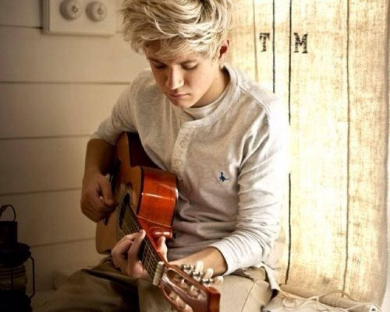 Niall Horan Playing Guitar Wallpaper