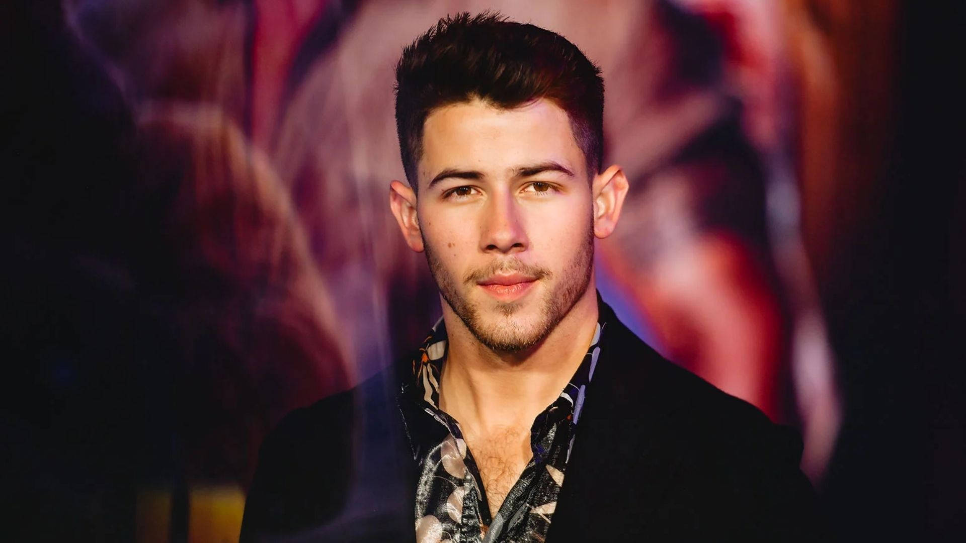 Nick Jonas With Colorful Lights Wallpaper