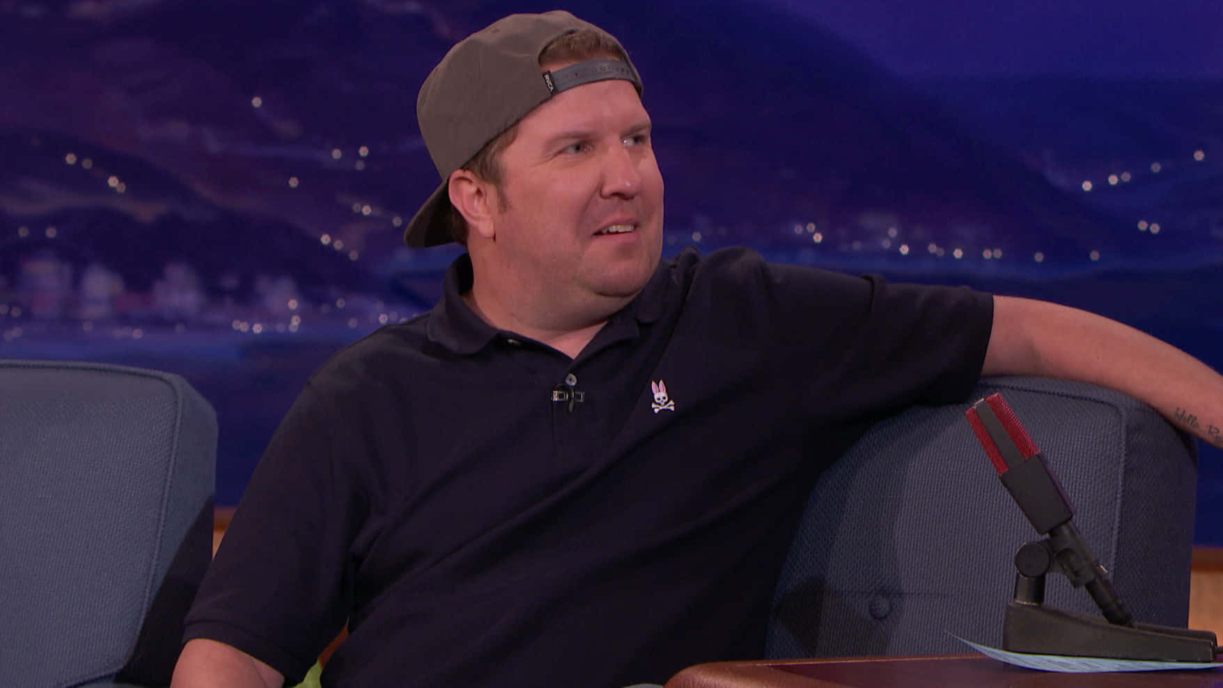 Nick Swardson, grinning in front of the camera. Wallpaper