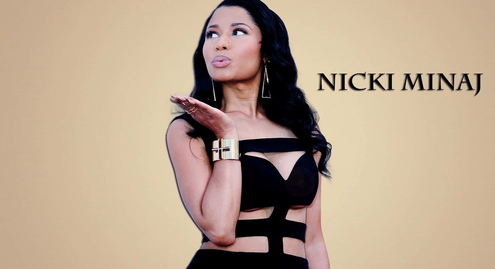 Nicki Minaj strikes a fierce pose in a colorful outfit